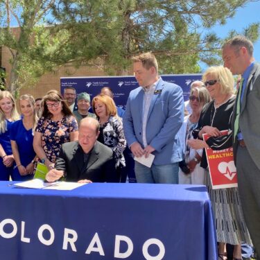 Gov. Polis signs bill that covers tuition for short-term healthcare programs.