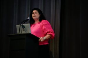 Dr. Denise Henning speaks behind a podium