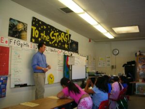 Dr. Mascareñaz teaches a group of first graders in a classroom