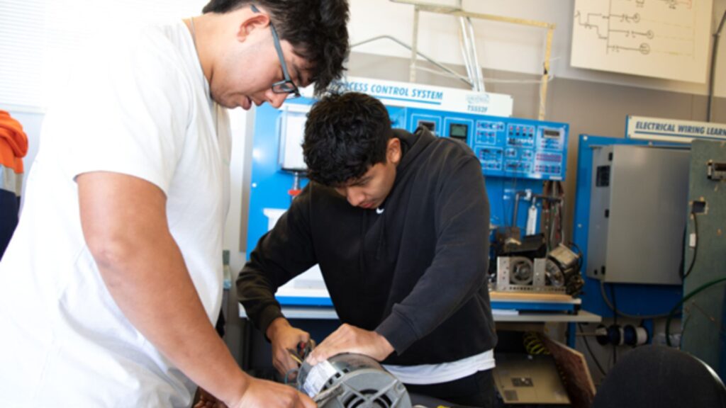 Photo of two Morgan Community College students working on motor controls.