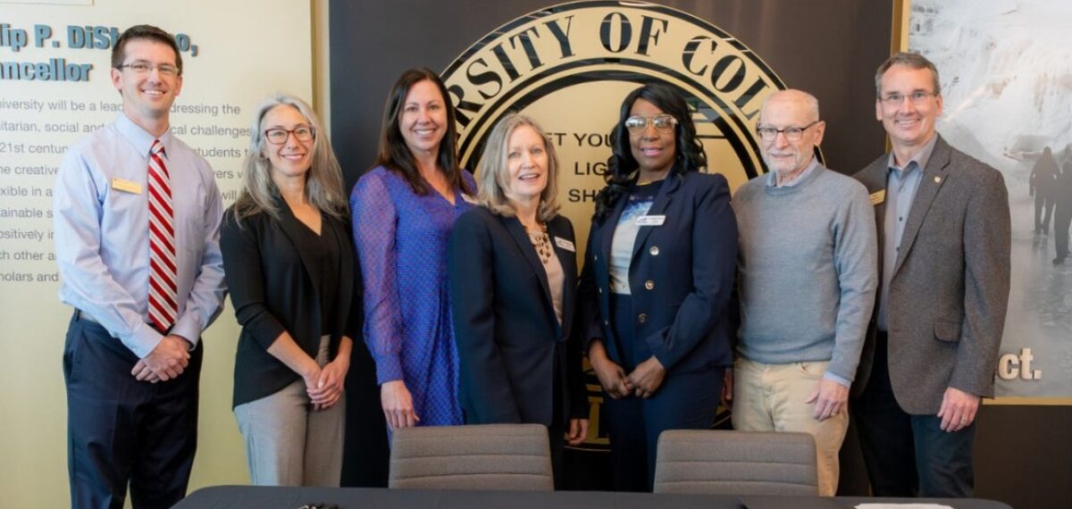 Photo of Dr. Colleen Simpson, president of Front Range Community College, and Russell Moore, provost and executive vice chancellor for academic affairs for CU Boulder, and other higher education leaders at a signing ceremony on the CU Boulder campus.